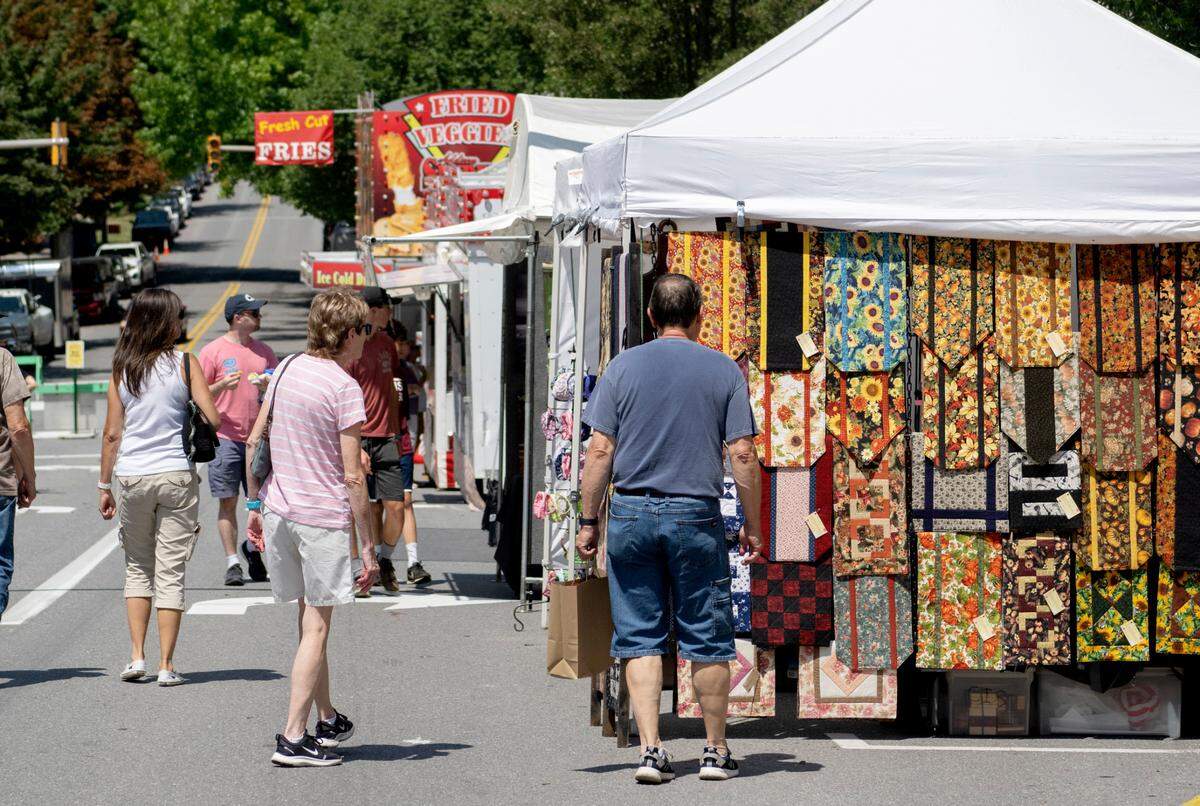 Visitors browse booths on Allegheny Street during the 39th Annual Bellefonte Arts and Crafts Fair on Friday, Aug. 5, 2022.
