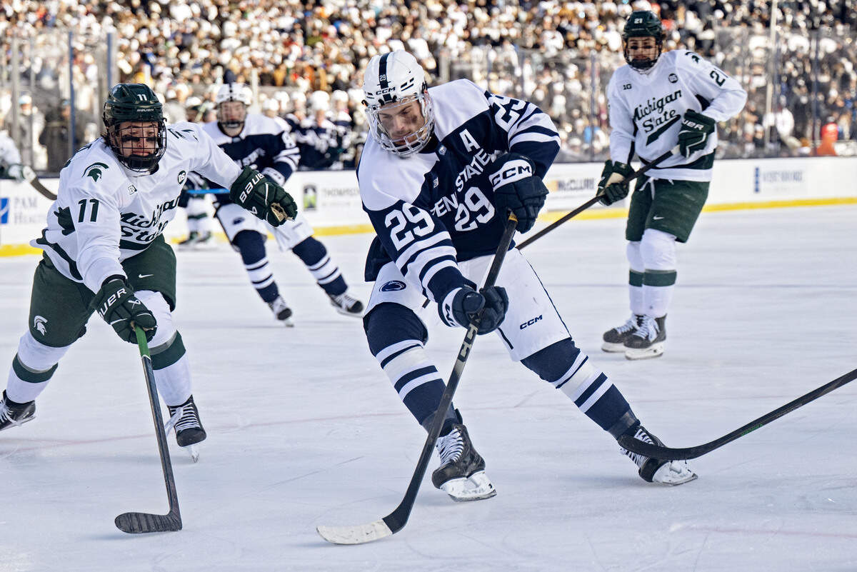 Penn State's Reese Laubach cuts down the ice with the puck around Michigan State’s Owen West during the game on Saturday, Jan. 31, 2026 at Beaver Stadium.