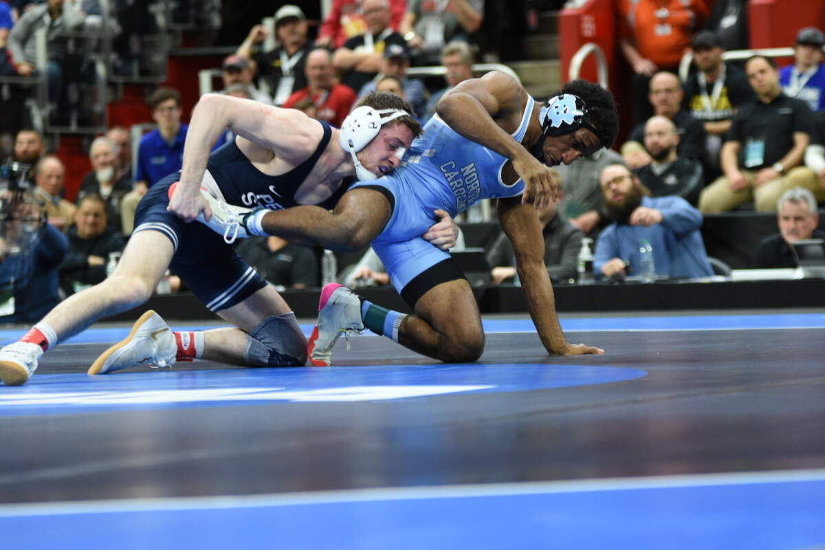 Penn State’s Nick Lee controls North Carolina’s Kizhan Clarke in their 141-pound finals match of the NCAA Championships on Saturday, March 19, 2022 at Little Caesars Arena in Detroit. Lee beat Clarke, 10-3, for his second straight title.