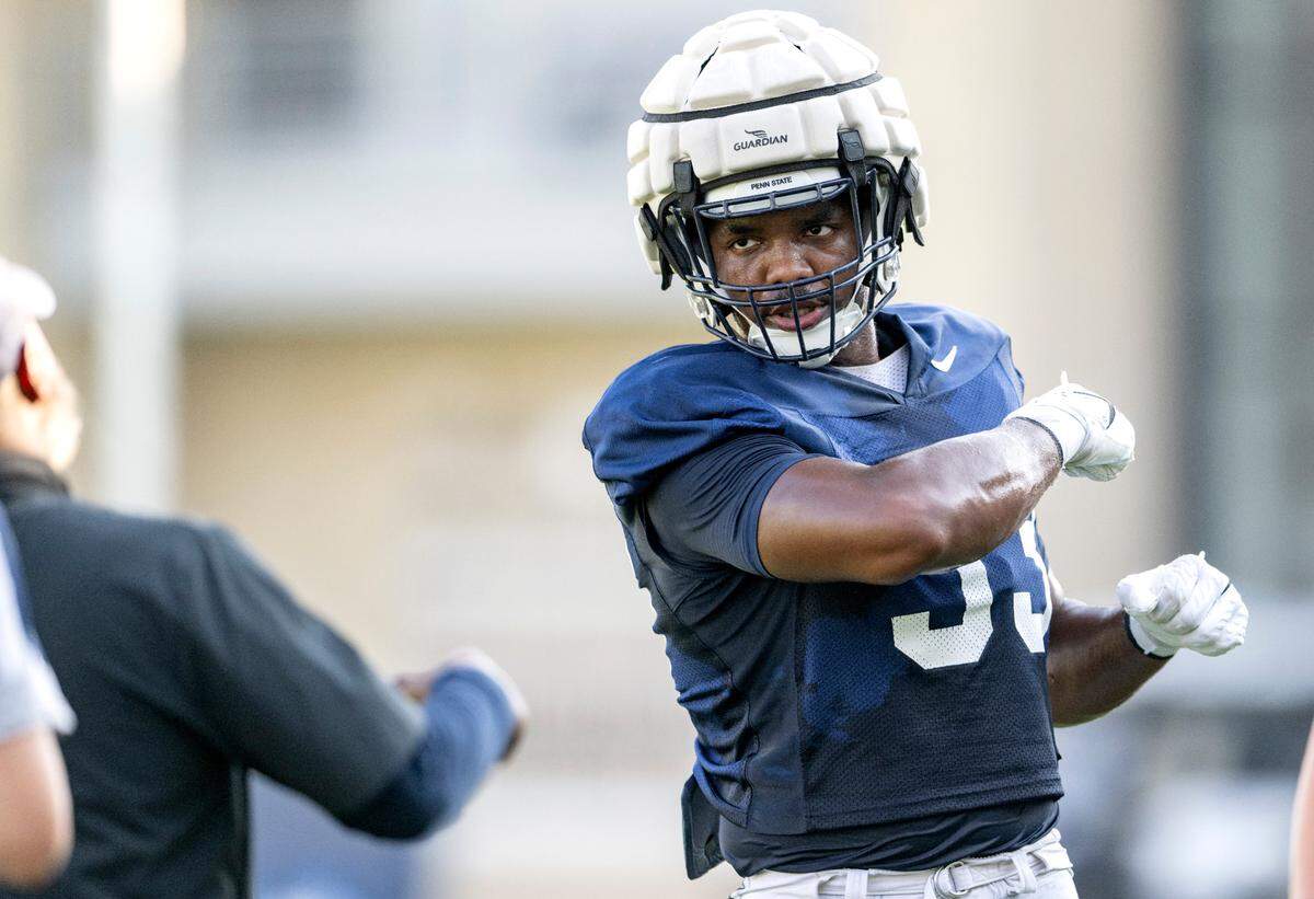 Penn state defensive end Dani Dennis-Sutton talks technique with coach Terry Smith during practice on Wednesday, Sept. 6, 2023.
