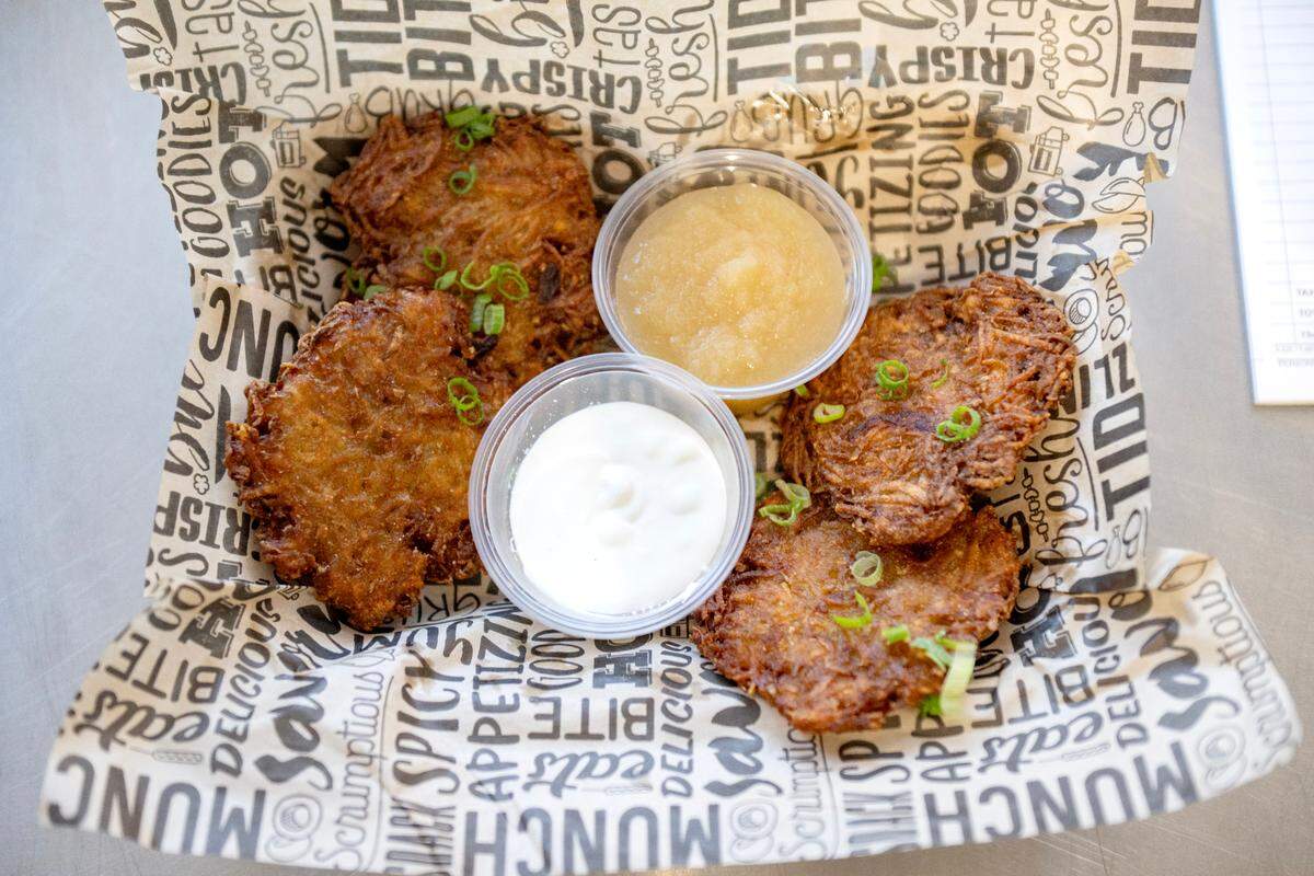 Potato latkes served with applesauce and sour cream from Dubbs Grub on Friday, Jan. 17, 2025.