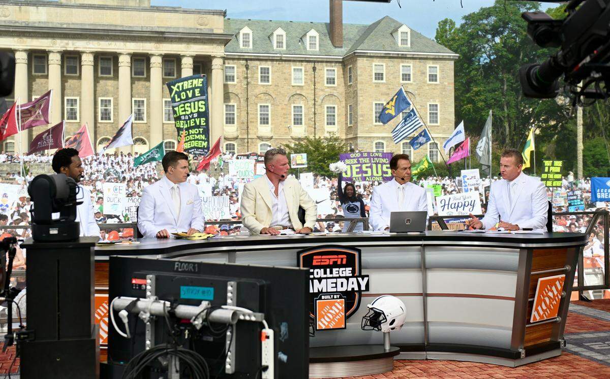 The crew of ESPN’s College GameDay sits in front of Old Main on Penn State’s campus, ahead of Saturday night’s Penn State vs. Oregon college football game, on Saturday, Sept. 27, 2025. They’re wearing white as a nod to the Nittany Lions’ annual White Out.
