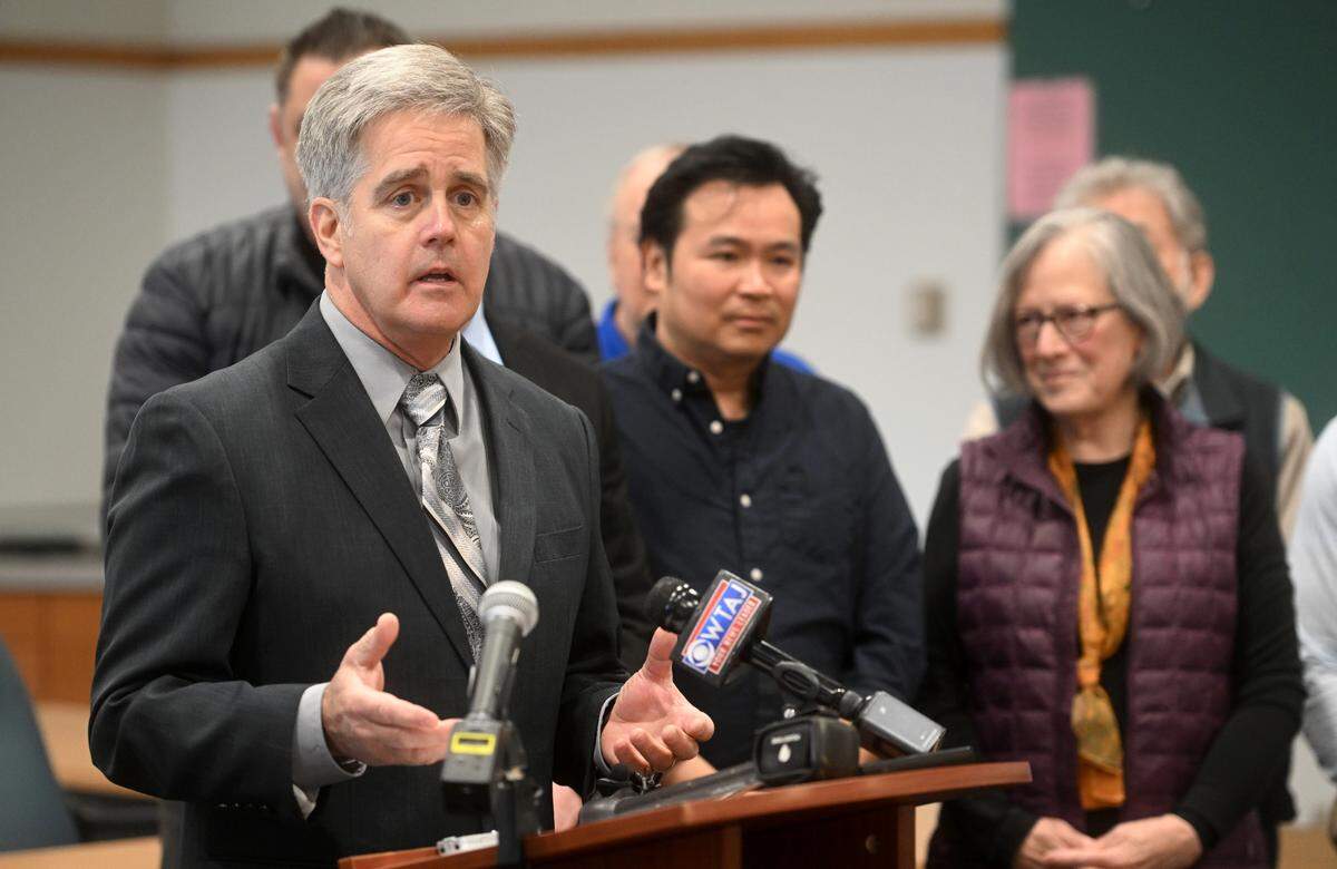 Surrounded by residents of the Georgetown Park Community and members of the Patton Township board of supervisors, Rep. Scott Conklin announces a state grant Monday to help the families whose homes were damaged by the large sinkhole on Amblewood Way in December.