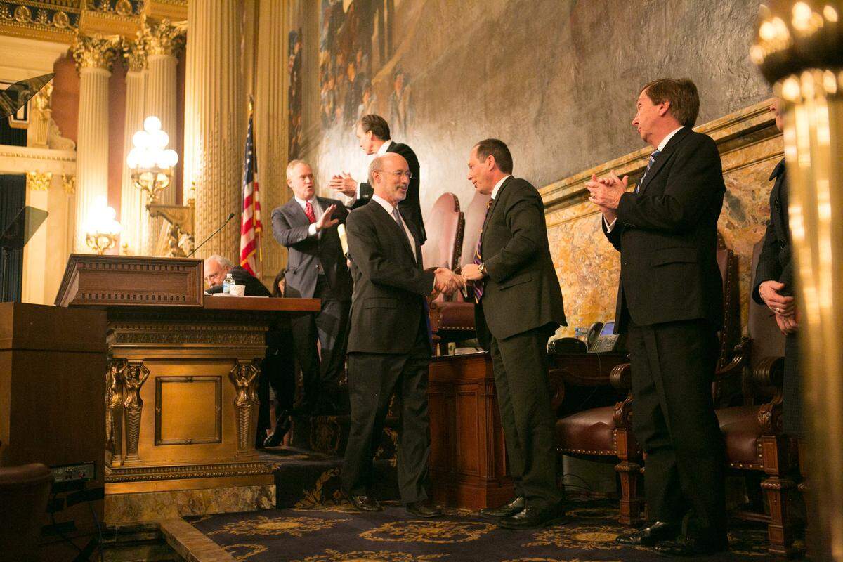 Pennsylvania Senate President Pro Tempore Joe Scarnati, second from right, talks to former Gov. Tom Wolf in the Capitol.
