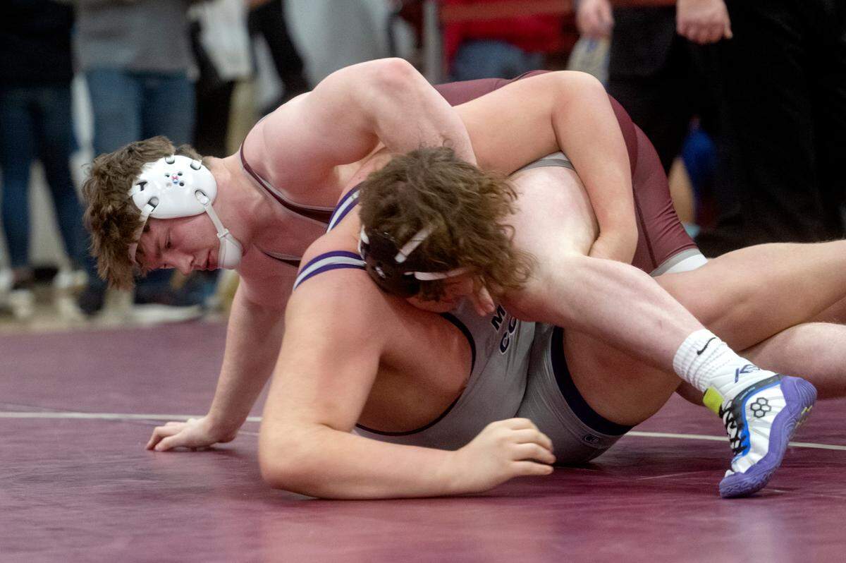 State College’s Nick Pavlechko rolls Miffling County’s Peyton Kearns in the 285 lb championship bout of the District 6 3A championships on Saturday, Feb. 18, 2023.