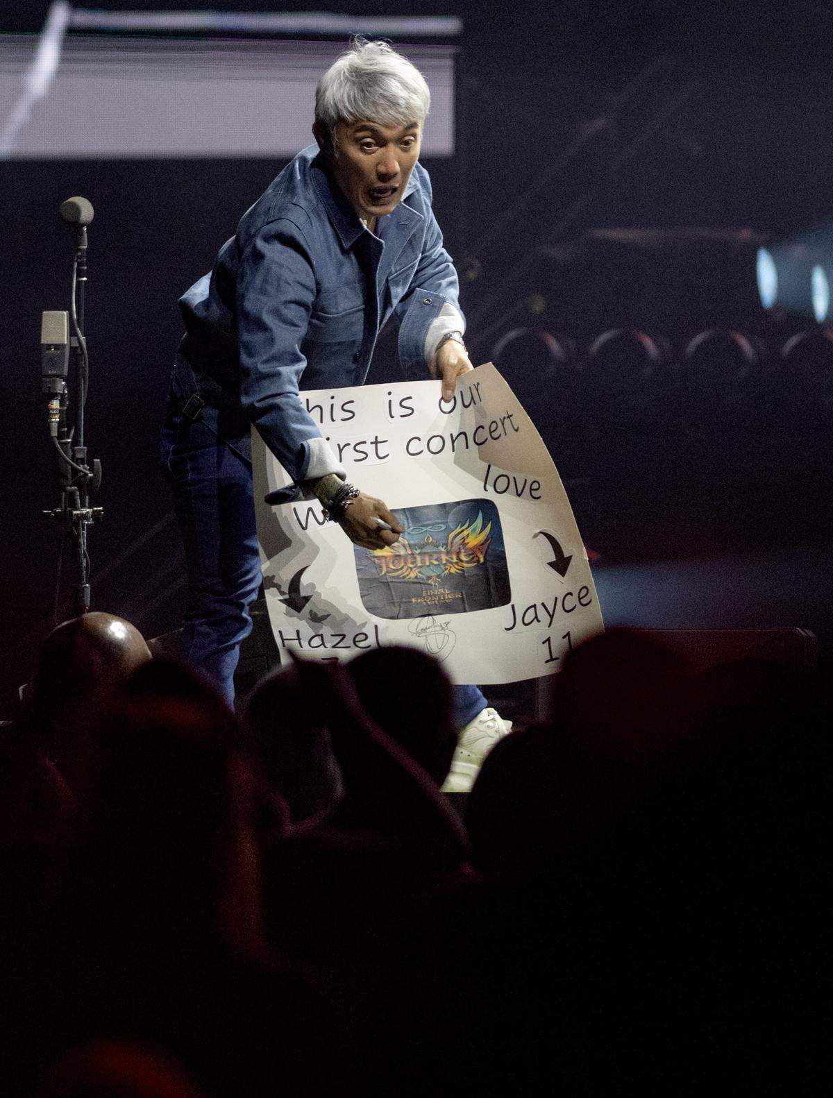 Arnel Pineda of Journey signs a poster for fans at the Bryce Jordan Center during the show on Wednesday, May 27, 2026.  