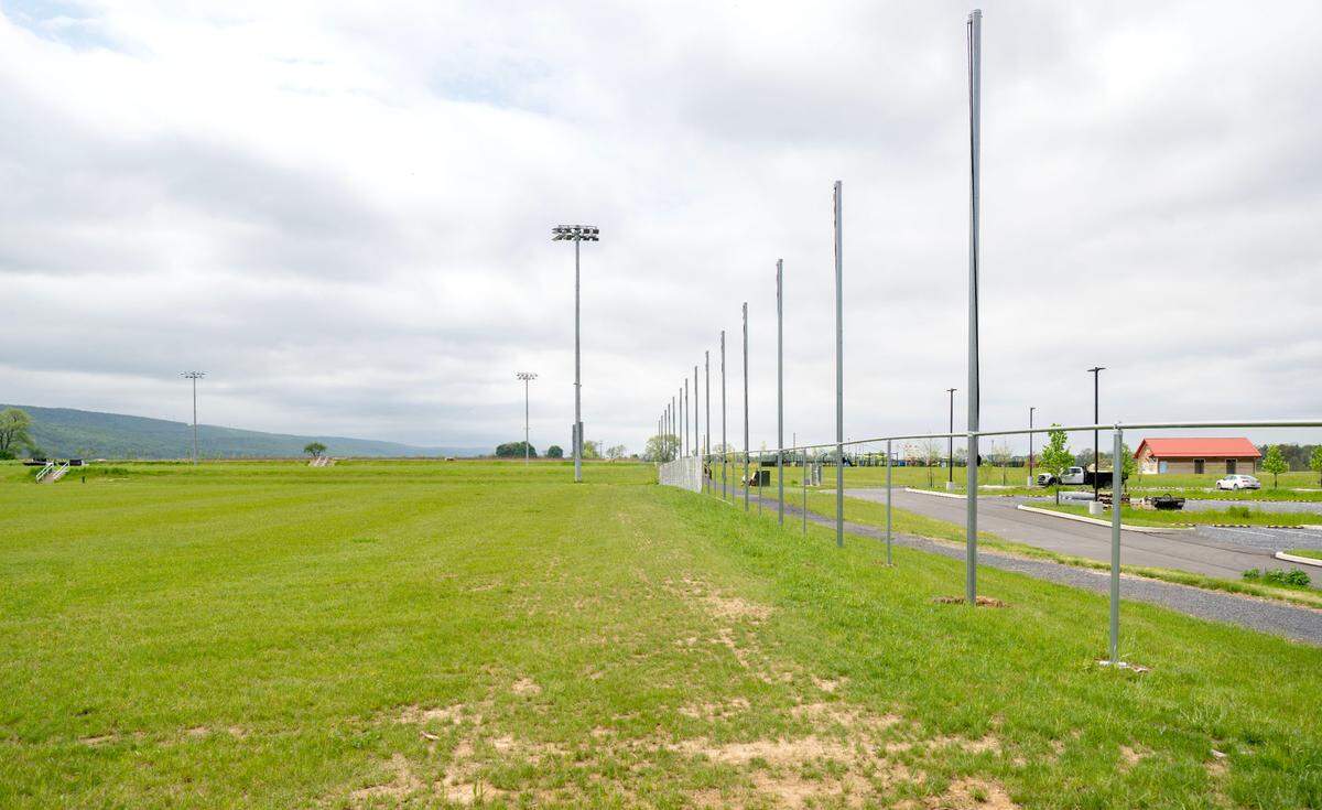 Fences are being installed along the premiere fields at Whitehall Road Regional Park on Tuesday.