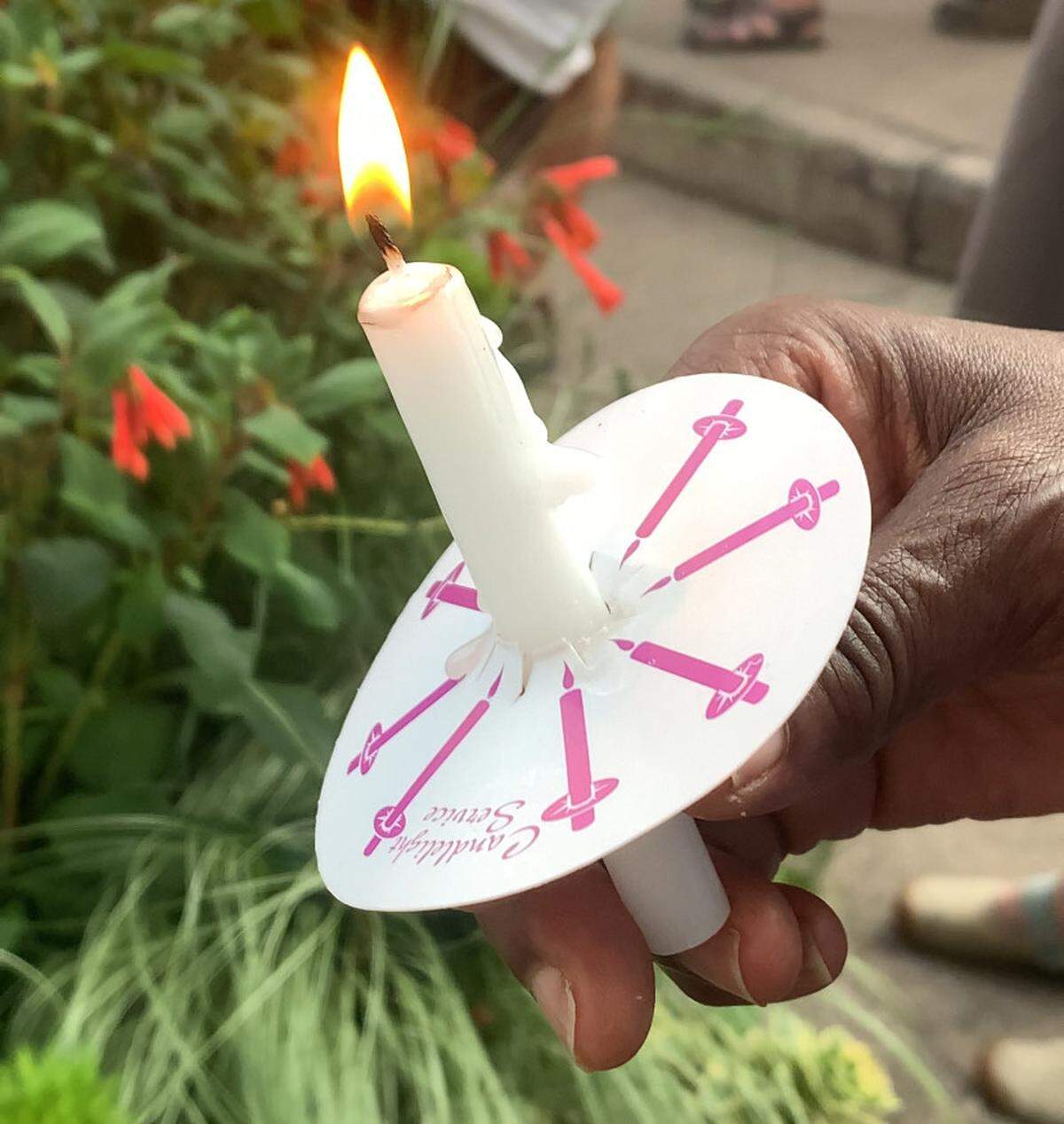 Protesters lit candles as the “Good Trouble Lives On” demonstration came to a close on Thursday, July 17, 2025.