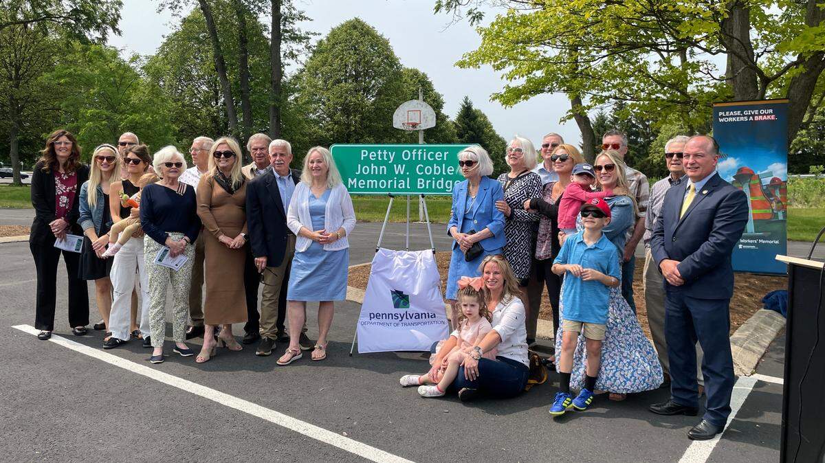 Rep. Kerry Benninghoff, far right, stands with multiple generations of the Coble family at a bridge dedication ceremony for the Petty Officer John W. Coble Memorial Bridge in Lemont.