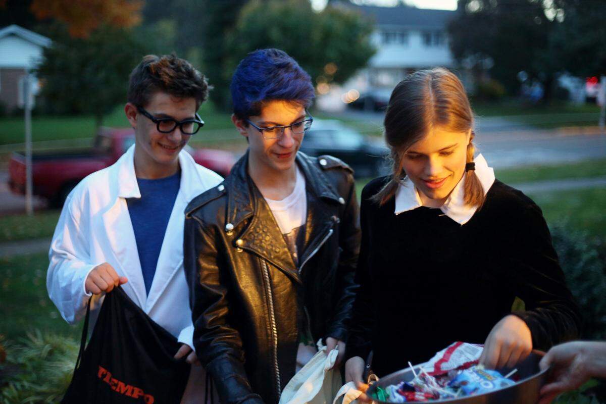 From right, Amelia Kasdorf, Sequoia Falcone and Jacob Sholtiz trick-or-treat Monday, Oct 31, 2016 in State College.