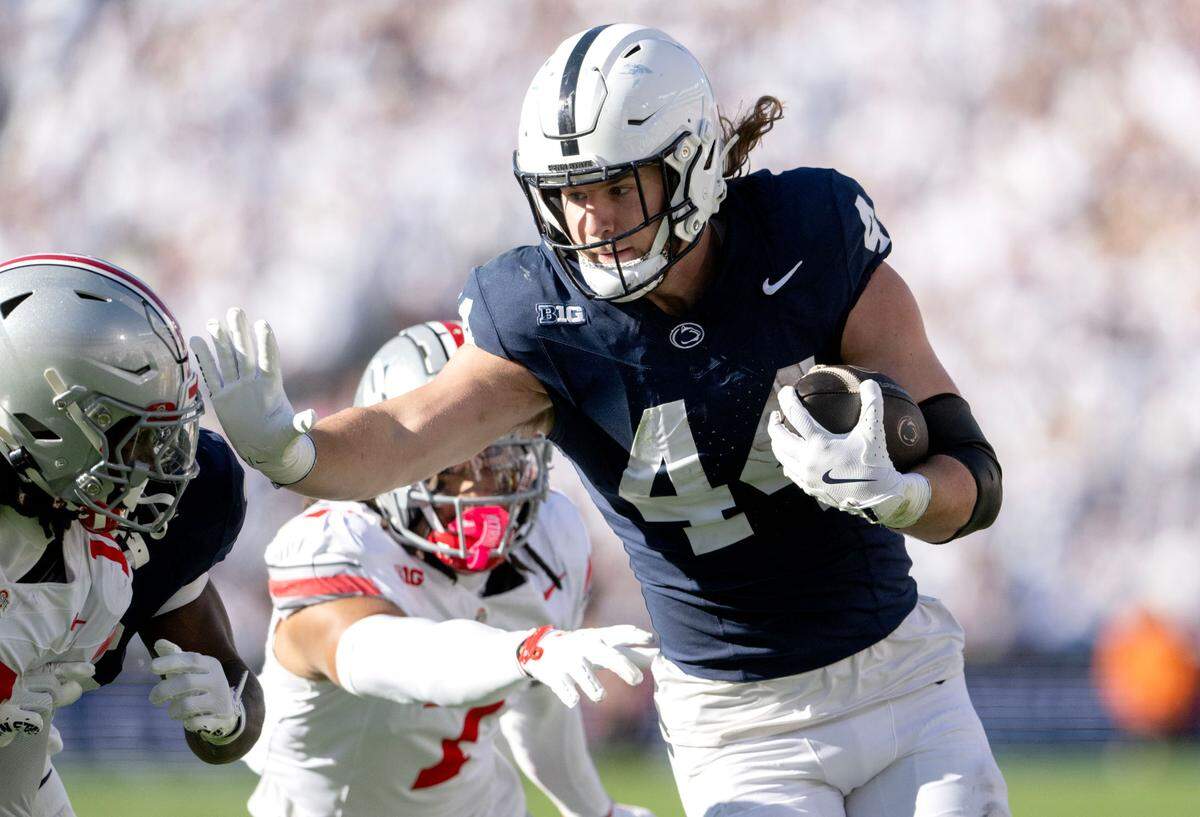 Penn State tight end Tyler Warren pushes past Ohio State defenders with the ball during the game on Saturday at Beaver Stadium.  