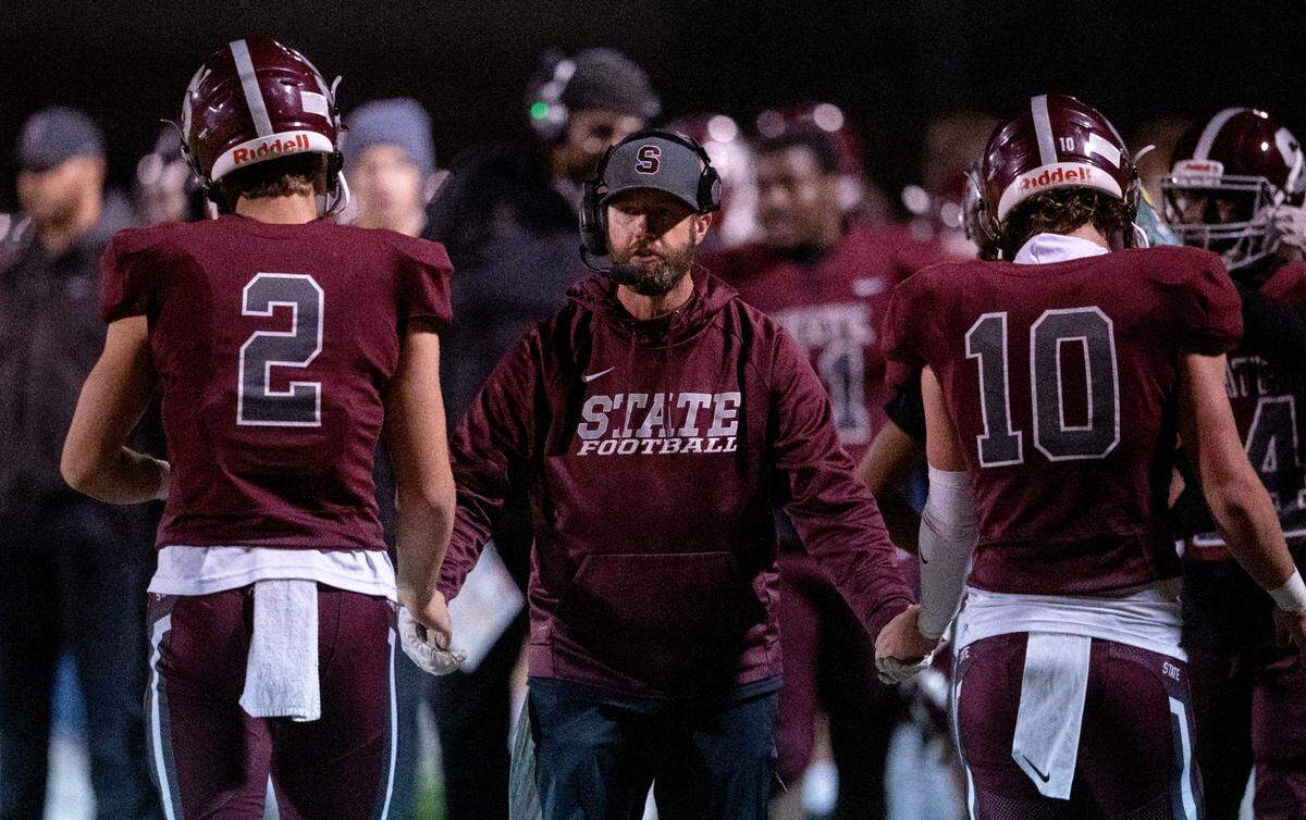 State College football coach Matt Lintal high-fives players after a touchdown during the District 6 6A championship game against Altoona at Bald Eagle Area on Thursday, Nov. 10, 2022. State College won, 28-7.