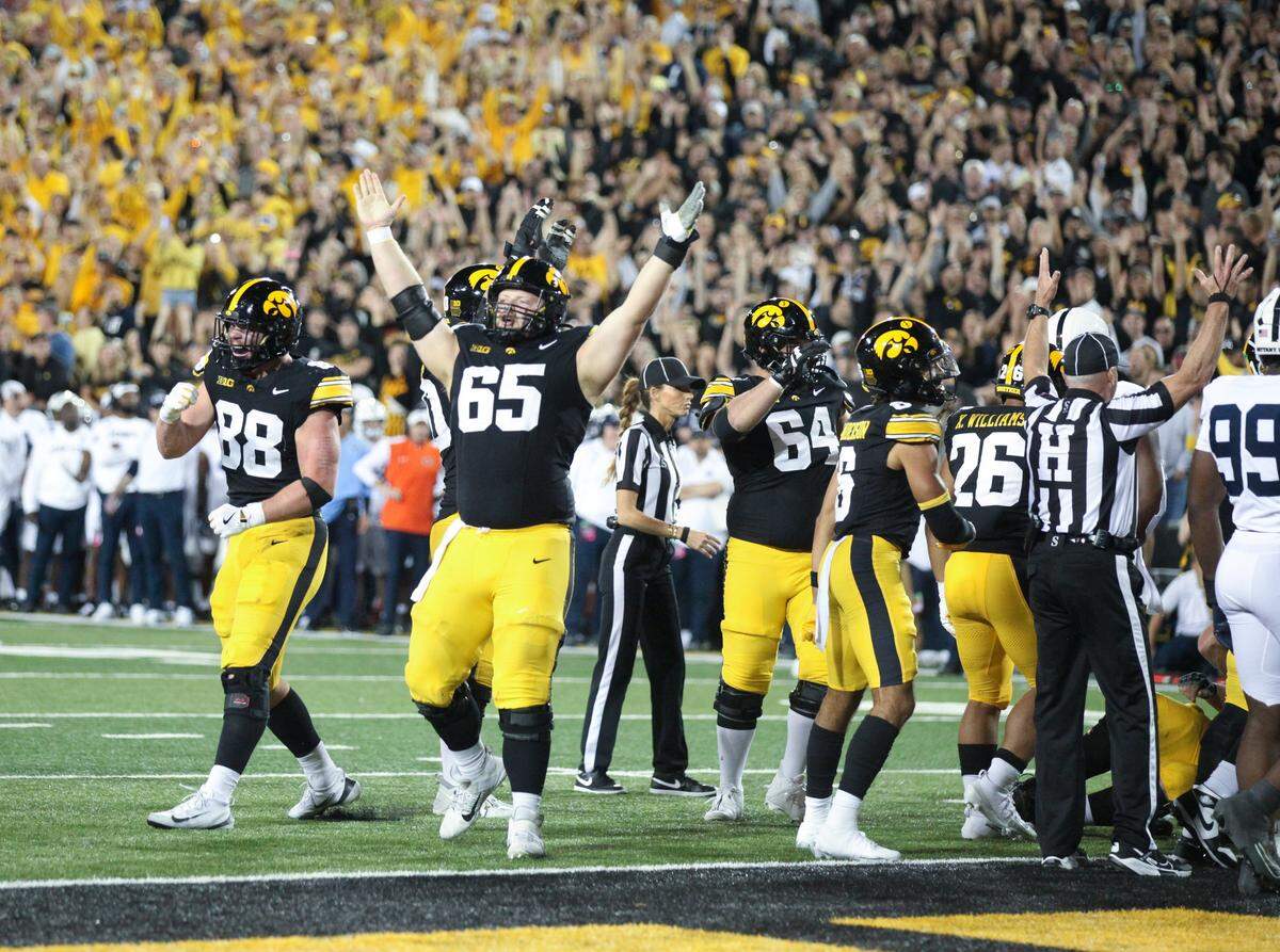IOWA CITY, IA - OCTOBER 18: Offensive lineman Logan Jones #65 of the Iowa Hawkeyes signals a touchdown in the first half against the Penn State Nittany Lions on October 18, 2025 at Kinnick Stadium, in Iowa City, Iowa. (Photo by Matthew Holst/Getty Images)
