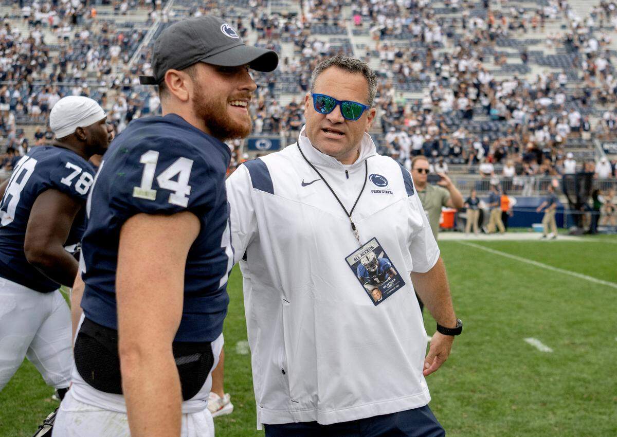 Penn State athletic director Pat Kraft congratulates quarterback Sean Clifford after the win over Ohio on Saturday, Sept. 10, 2022.