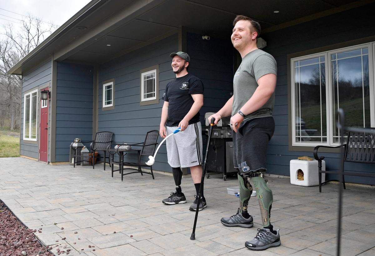 RJ Shirey laughs on April 1 as he and Adam Hartswick watch Adam’s German Shepherd, Arlo, sprint after a ball.