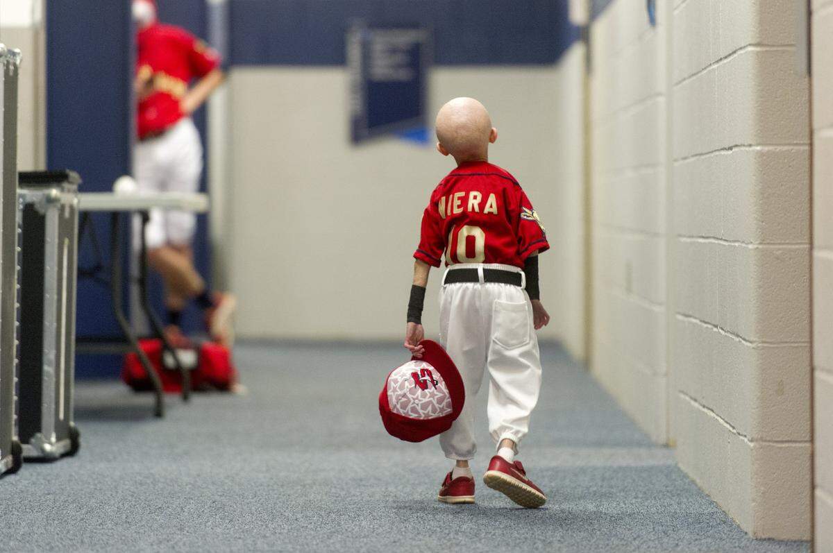 Josiah Viera walks down the State College Spikes' clubhouse hallway before the July 3, 2016 game. Progeria didn’t stop the 12-year-old from being the team’s honorary coach. 