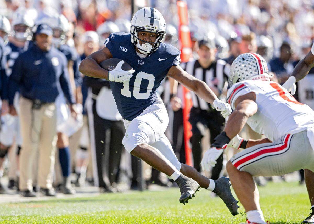 Penn State running back Nick Singleton cuts down the field with the ball from an Ohio State defender in the first quarter of the game on Saturday, Nov. 2, 2024 at Beaver Stadium.