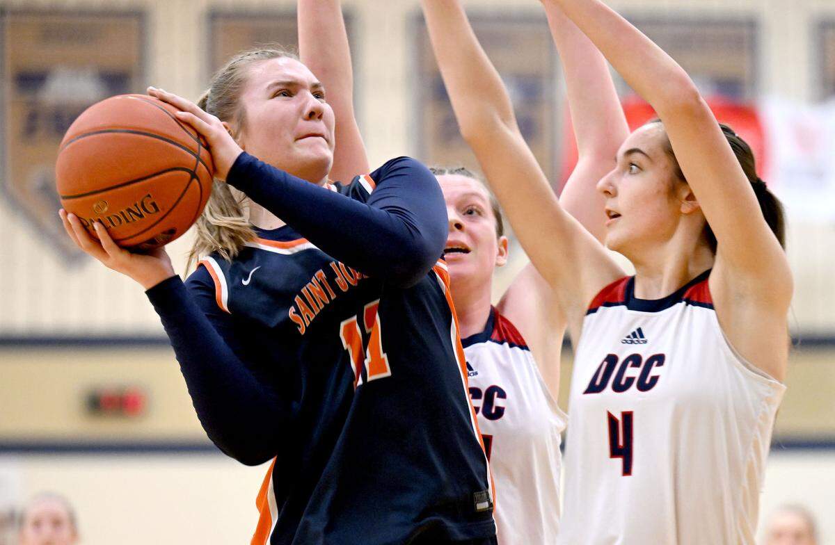 Saint Joseph’s Catholic Academy’s Aubrey Yartz looks to the basket around DuBois Central Catholic defenders during the game on Wednesday, March, 12, 2025 at Bald Eagle Area High School.