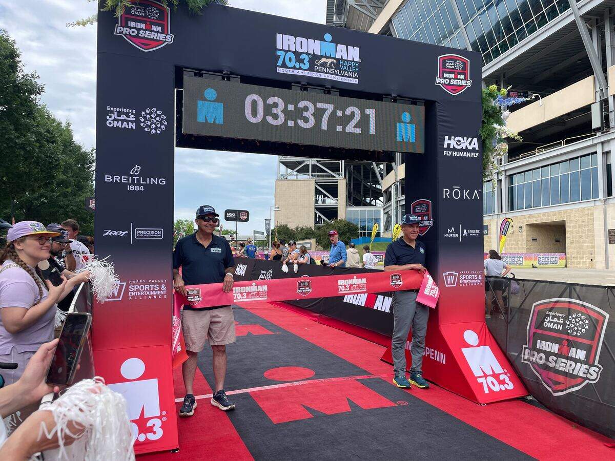 Happy Valley Adventure Bureau Board Chair Dave Capperella (left) and State Rep. Paul Takac, D-College Township, ready the finish line Sunday, June 14, 2026, at the Ironman 70.3 Pennsylvania Happy Valley North American Championship in Centre and Clinton counties.