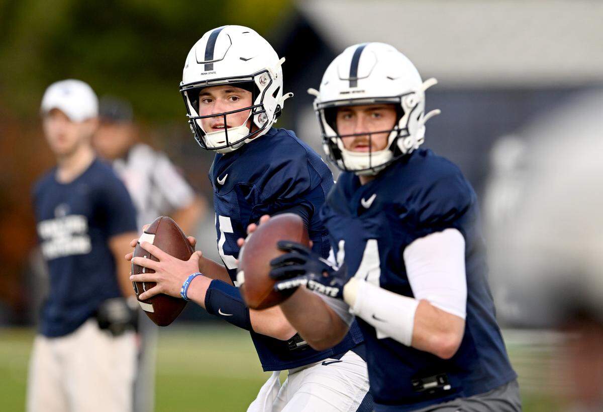 Penn State quarterbacks Drew Allar and Sean Clifford prep to make passes during a drill at practice on Wednesday, Nov. 2, 2022.