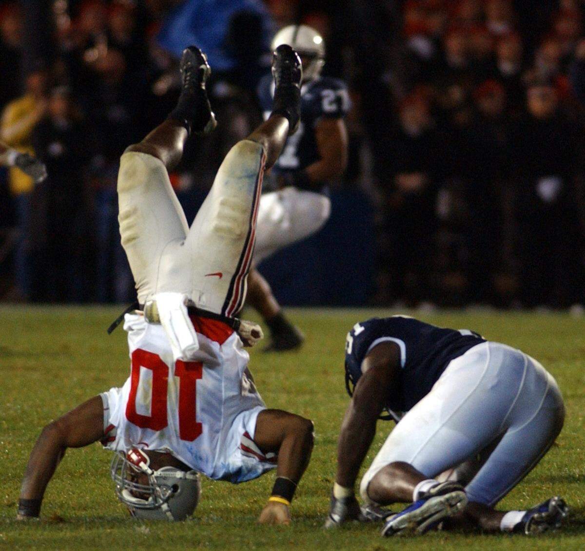 Tamba Hali hits Ohio State quarterback Troy Smith so hard he goes head over heels in the fourth quarter of the Penn State game against Ohio State at Beaver Stadium on Saturday, Oct. 8, 2005.
