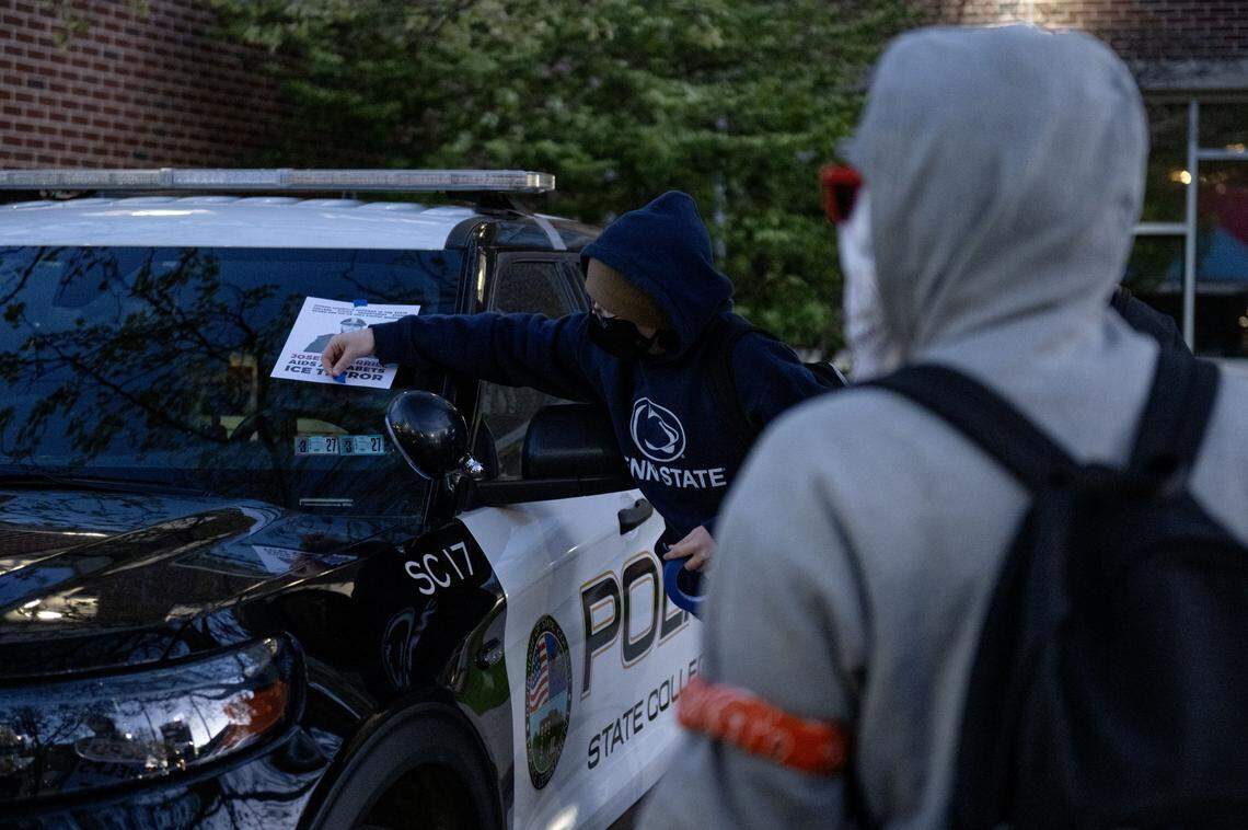 Protesters put flyers on State College Borough police cars outside of the State College Municipal building on Monday, April 20, 2026.  