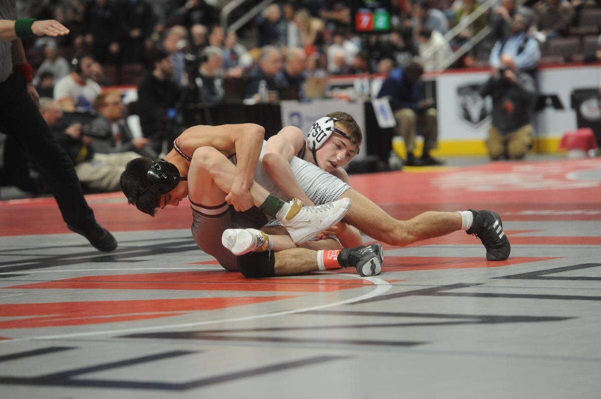 State College’s Asher Cunningham scrambles with West Chester Henderson’s Carmen Cortese in their 120-pound consolation second round match of the PIAA Class 3A Championships on Friday, March 11, 2022 at Giant Center in Hershey. Cunningham racked up an 11-2 major decision to stay in hunt for a medal.