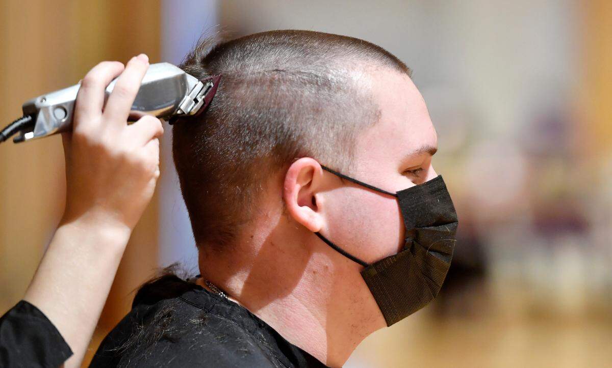 Michael Woods gets a buzz cut Tuesday during the Penn State Thon “No Hair, Don’t Care” event.