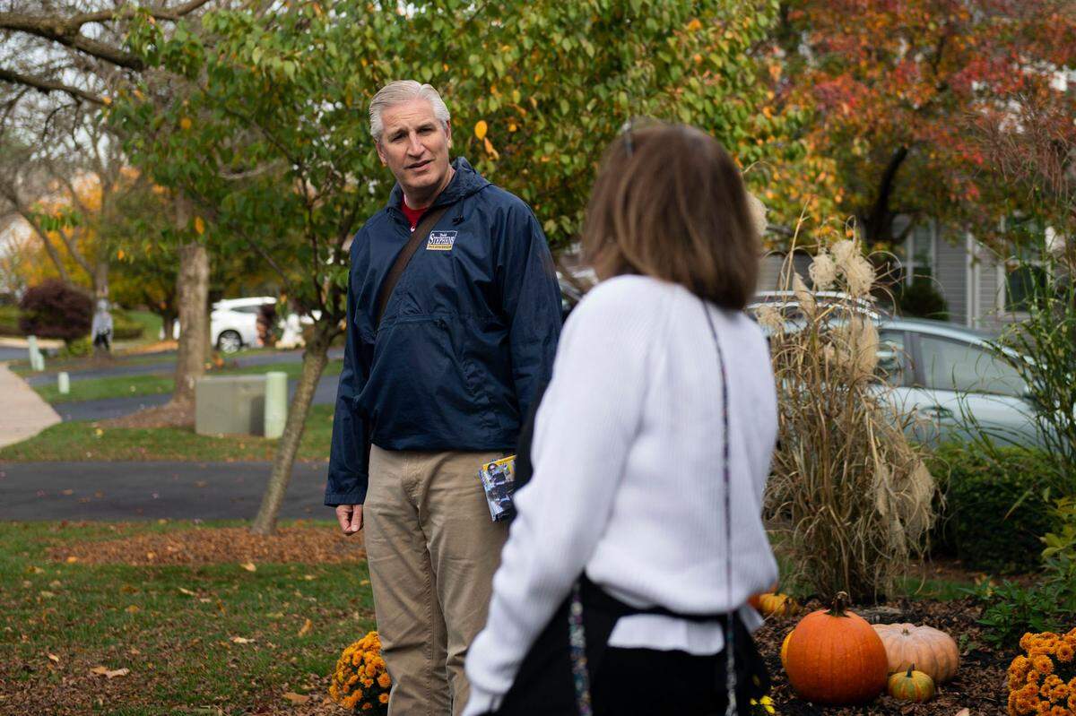Todd Stephens, left, a Republican state representative running for reelection, speaks with supporter Linda McKillen as he goes door-to-door in his district in October.