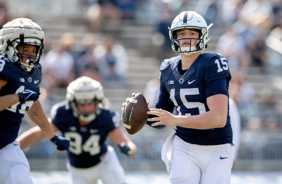 Penn State quarterback Drew Allar looks to make a throw while being pressured by the defense during the Blue-White game on Saturday, April 23, 2022.