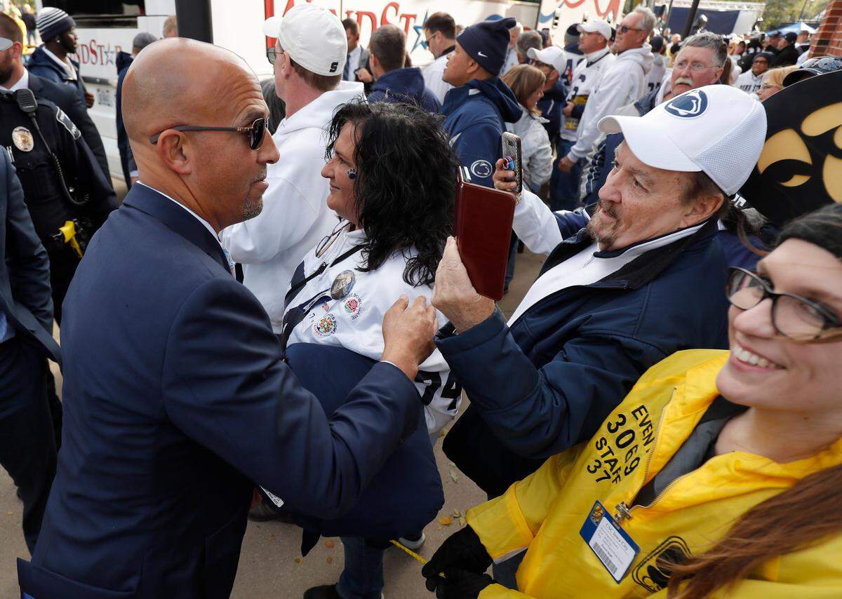 Penn State coach James Franklin, left, greets fans as he arrives for the team’s NCAA college football game against Iowa, Saturday, Oct. 12, 2019, in Iowa City, Iowa. (AP Photo/Matthew Putney)