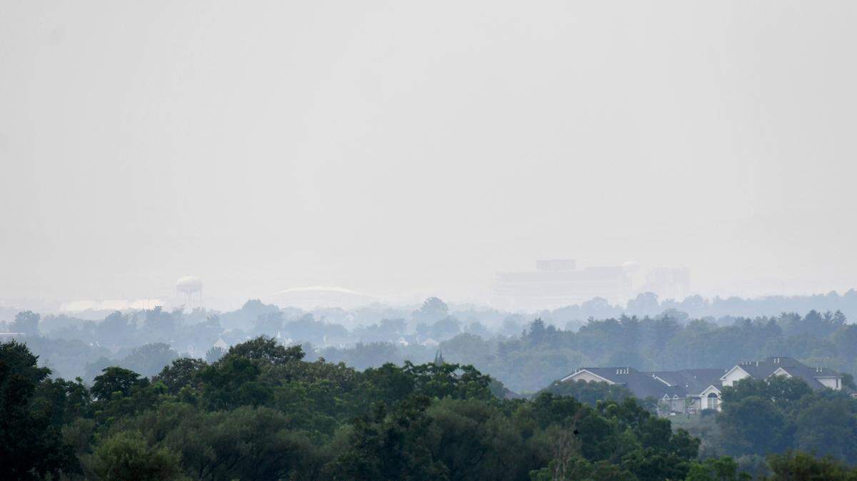 Haze makes it hard to see Beaver Stadium and the Bryce Jordan Center from Harvest Fields on Tuesday, July 20, 2021.
