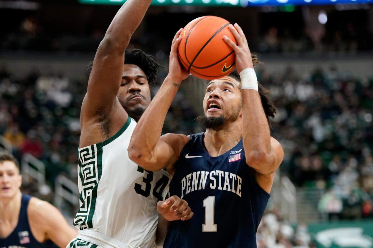 Penn State forward Seth Lundy (1) is defended by Michigan State forward Julius Marble II (34) during the first half of an NCAA college basketball game, Saturday, Dec. 11, 2021, in East Lansing, Mich.