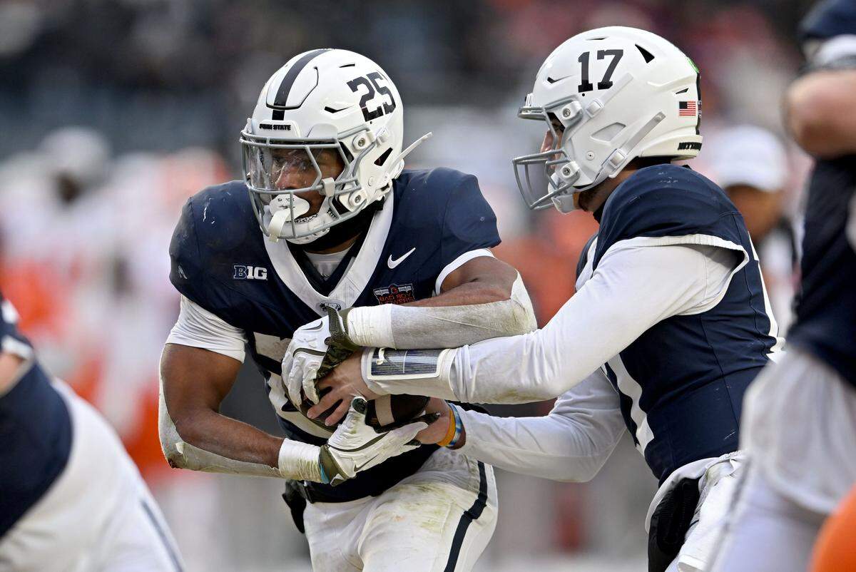 Penn State quarterback Ethan Grunkemeyer hands off to running back Quinton Martin Jr. during the Pinstripe Bowl at Yankee Stadium on Saturday, Dec. 27, 2025.