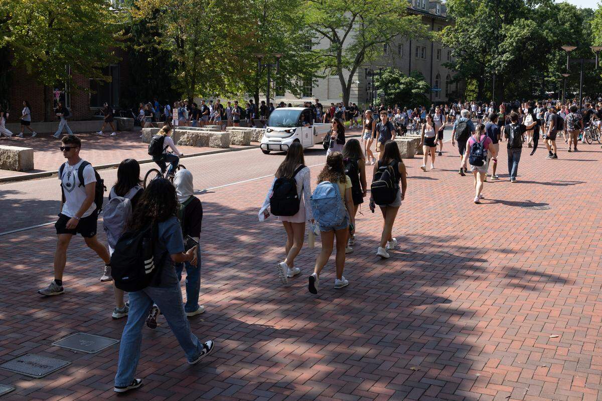 Penn State students walk through campus on the first day of classes on Monday, Aug. 26, 2024.