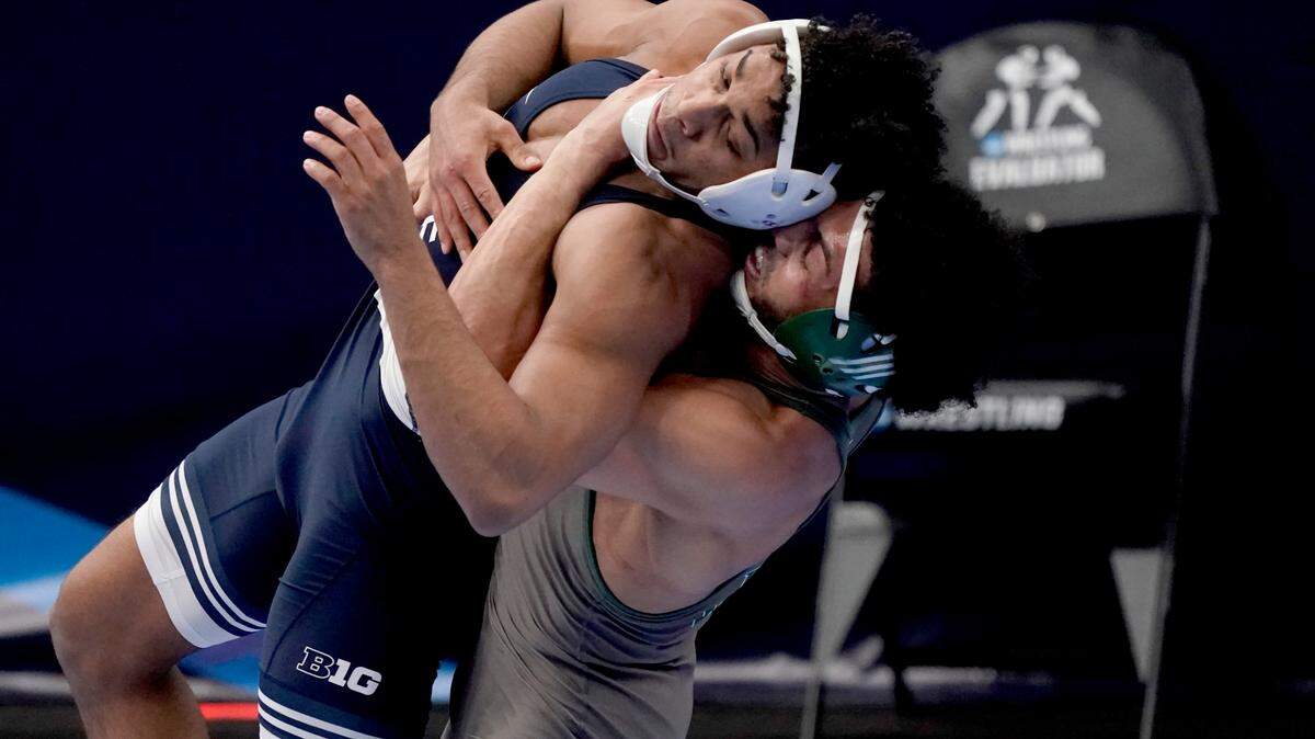Penn State’s Carter Starocci, left, is lifted up by Utah Valley’s Demetrius Romero during their 174-pound match in the semifinal round of the NCAA wrestling championships Friday, March 19, 2021, in St. Louis.