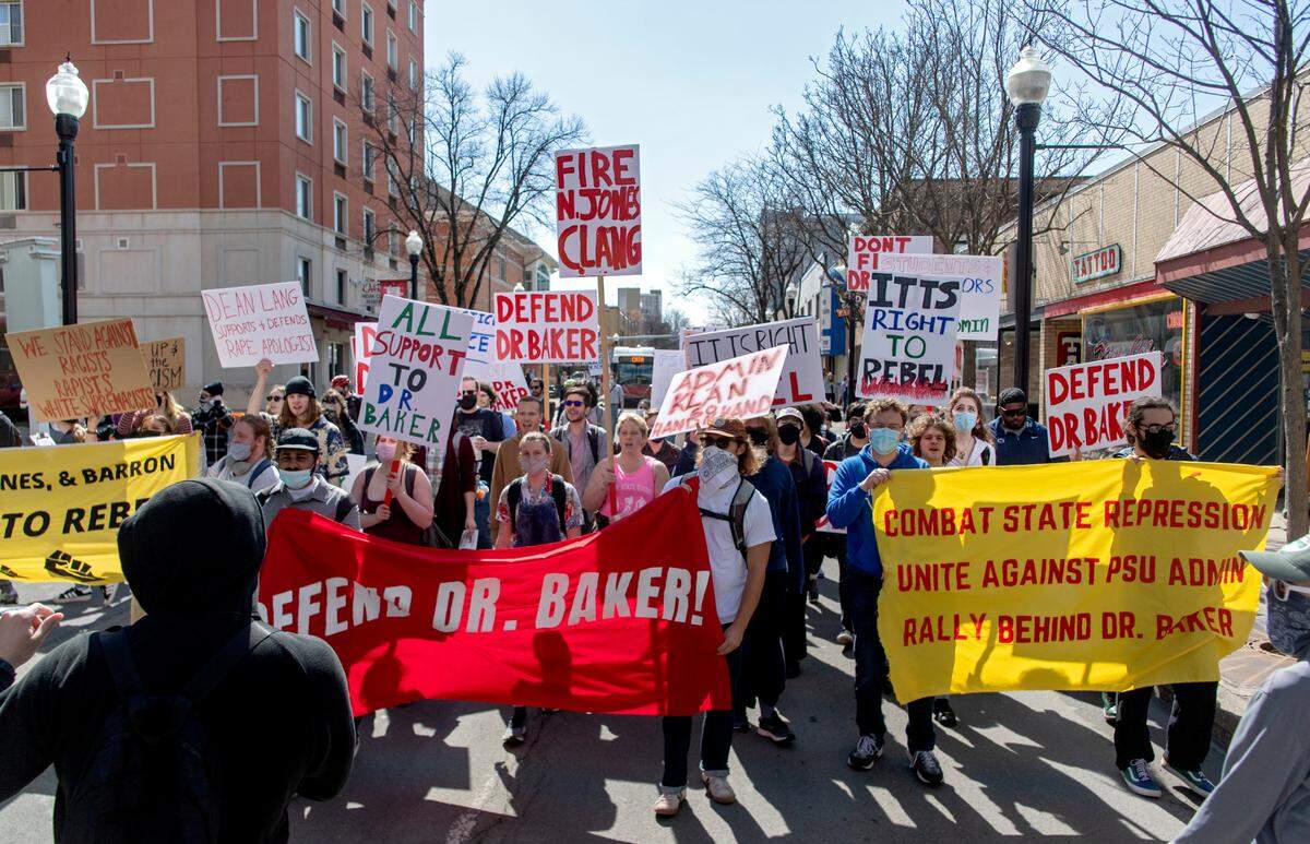 Protesters walk down the middle of Beaver Avenue on Thursday in support of a Penn State professor who’s facing termination.