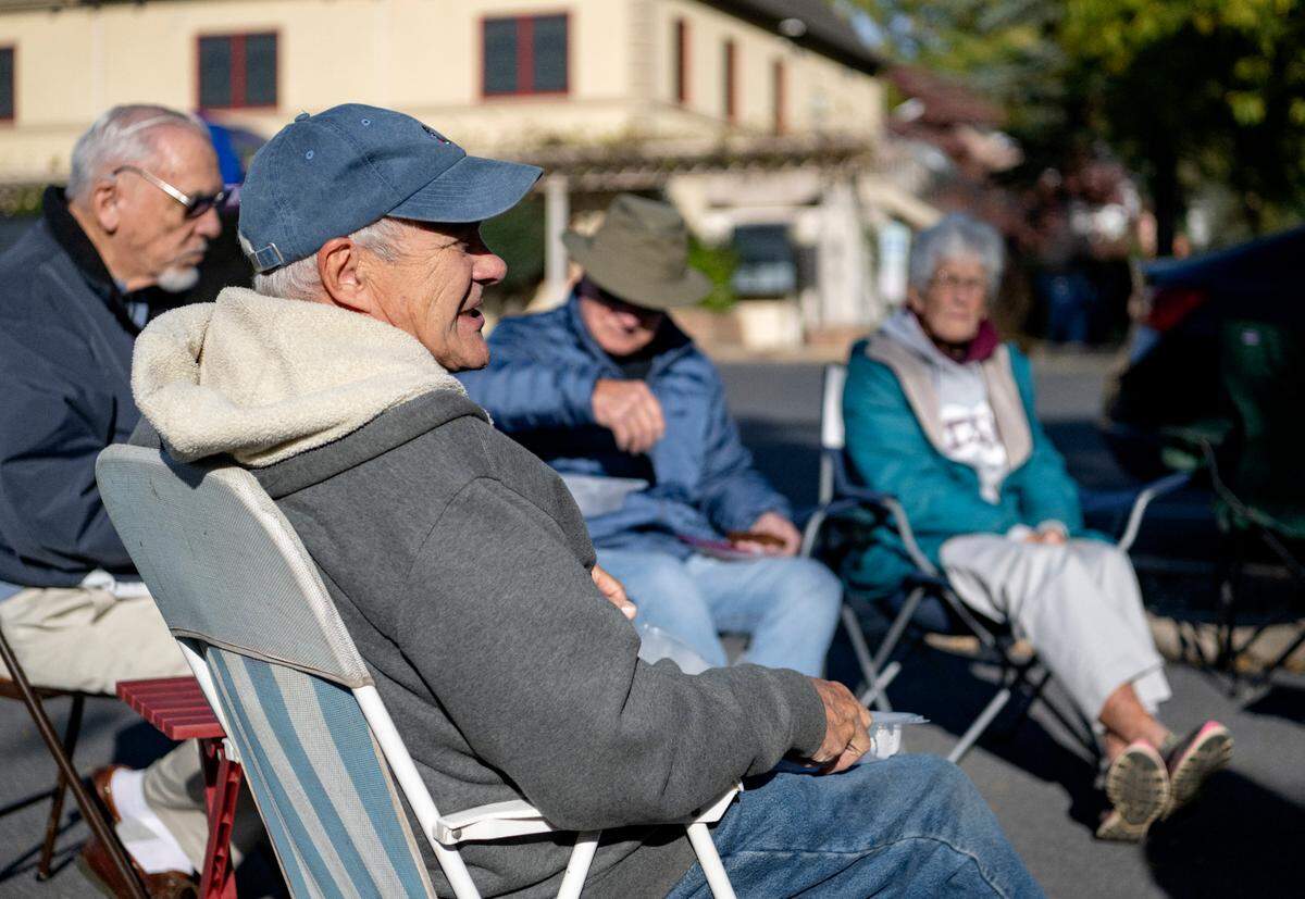 Barry Rossman laughs with friends and fellow retired educators Wednesday during their weekly meetup in the parking lot of the Waffle Shop.