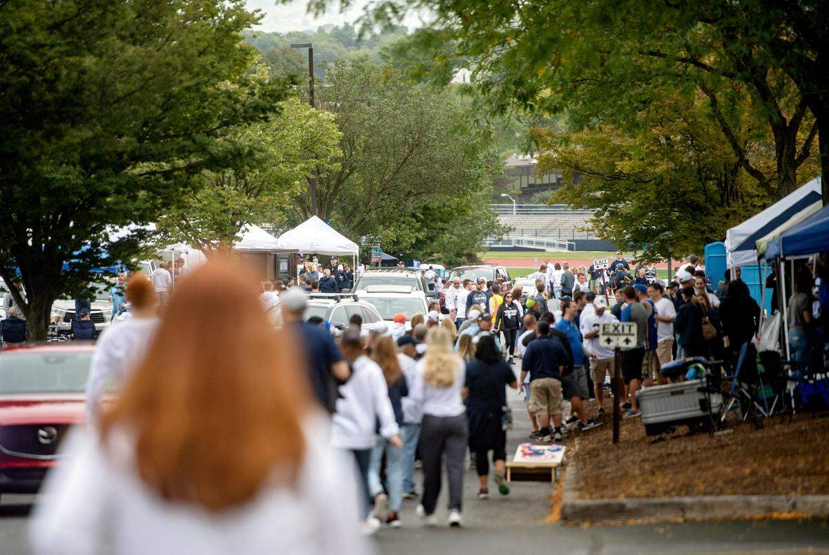 Cars try to make their way through tailgaters to their parking spots two hours before the Penn State football game against Pitt on Saturday.