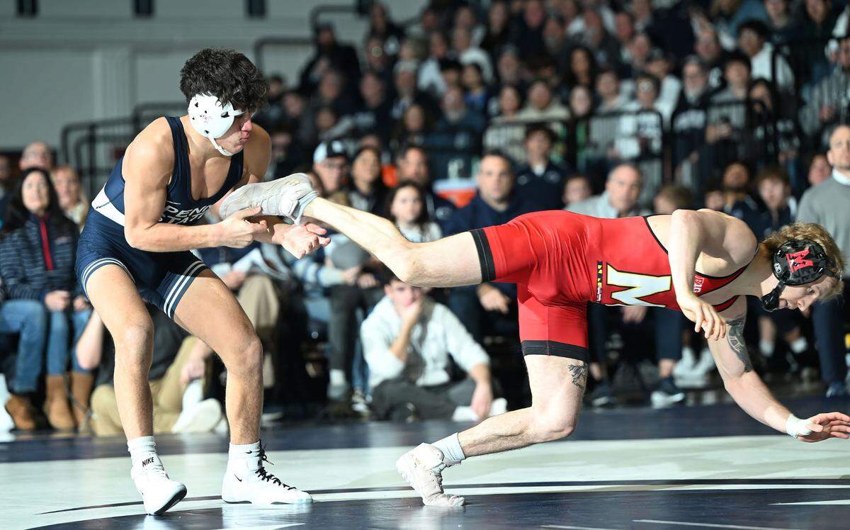 Penn State’s Kyison Garcia trips up Maryland’s Braxton Brown at 133 lbs. during Sunday’s meeting at Rec Hall in State College. Brown defeated Garcia, 9-1.