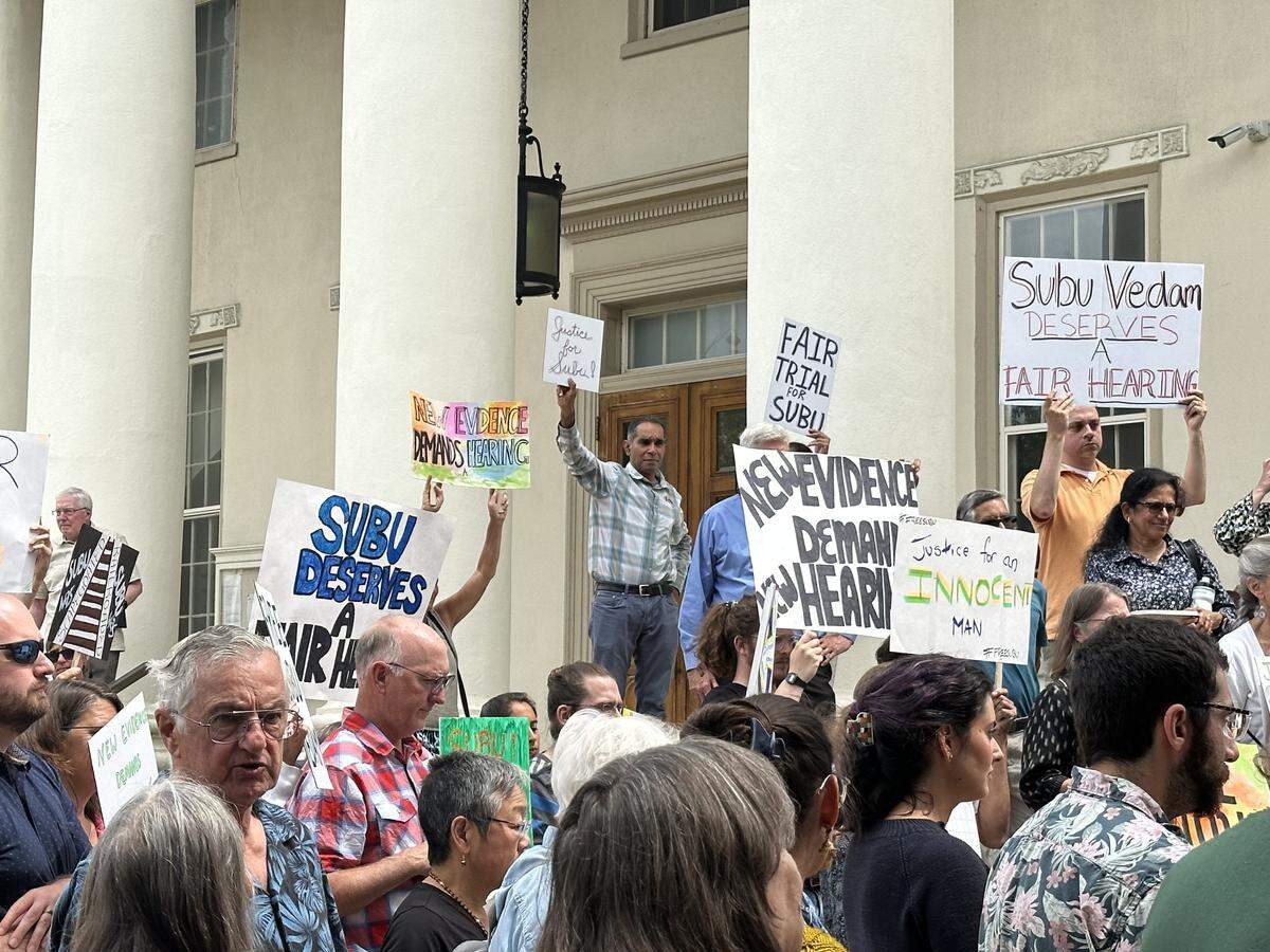 Supporters of Subramanyam Vedam hold up signs outside the Centre County Courthouse on Monday, July 22, 2024.
