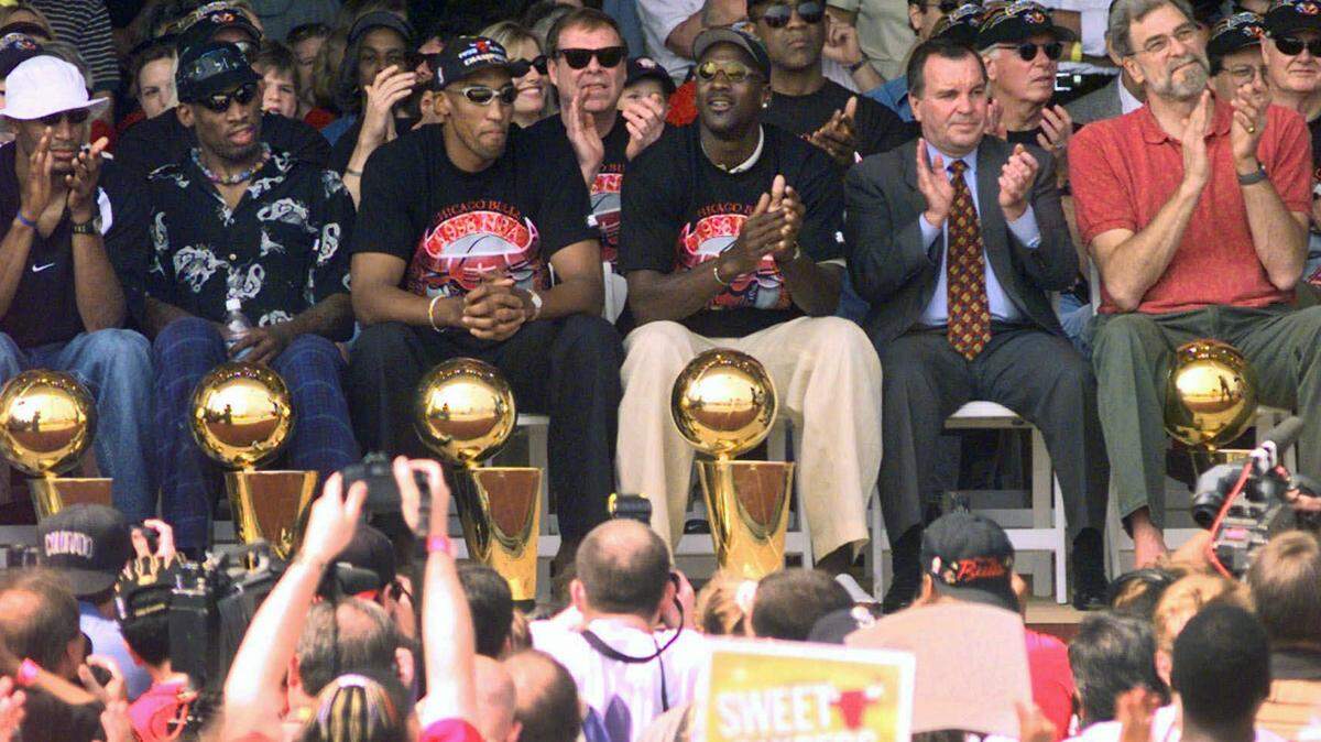 In this June 16, 1998, file photo, NBA Champions, from left: Ron Harper, Dennis Rodman, Scottie Pippen, Michael Jordan and coach Phil Jackson are joined on stage by Chicago Mayor Richard Daley, second from right, during a city-wide rally in Chicago to celebrate the Chicago Bulls sixth NBA championship.
