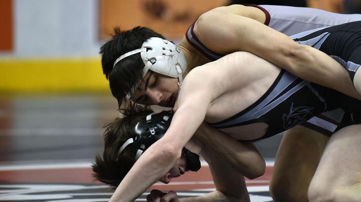 State College’s Owen Woolcott, top, wrestles with Strath Haven’s Chase Barlow in the 126-pound consolation bracket at the Class 3A PIAA Wrestling Championships on Thursday at Hershey’s Giant Arena. Woolcott beat Barlow 2-0.