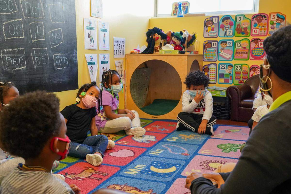 Tanisha Baylor, right, during “circle time” with the 4-year-old students under her care at The Willow School. The Montgomery County center for children has been significantly impacted by staffing shortages.