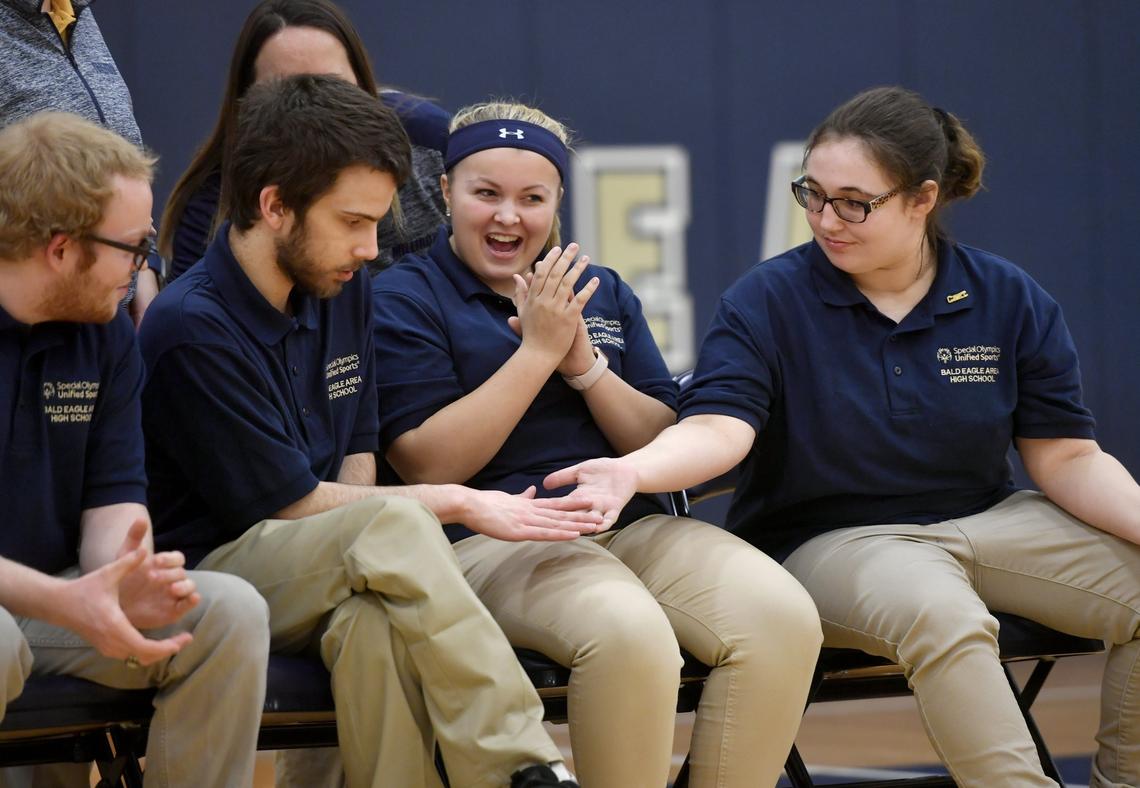 Bald Eagle Area’s Jordan Bonsell gets high fives from teammate Emily Gardner during the unified bocce match against State College on Thursday.