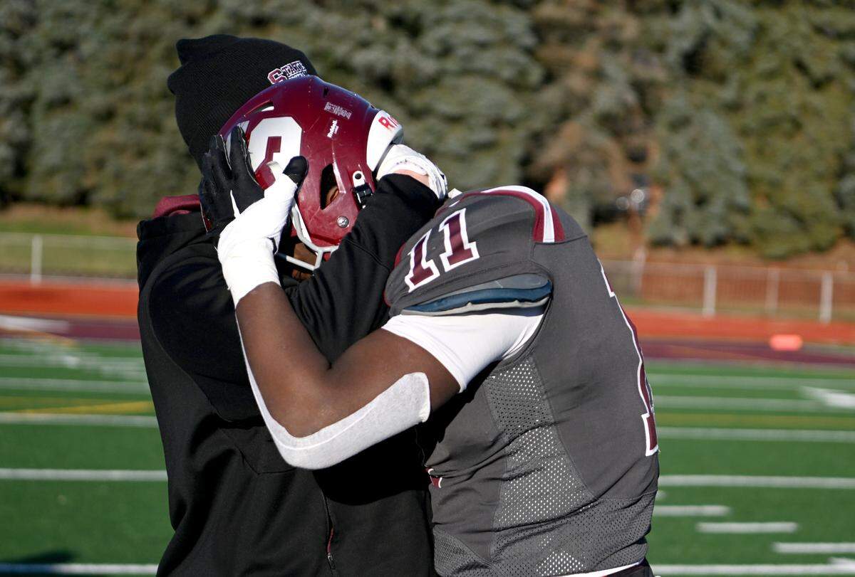 State College football coach Matt Lintal hugs senior John Scott after the loss to Harrisburg in the PIAA 6A semifinal game at Mansion Park on Saturday, Dec. 3, 2022.