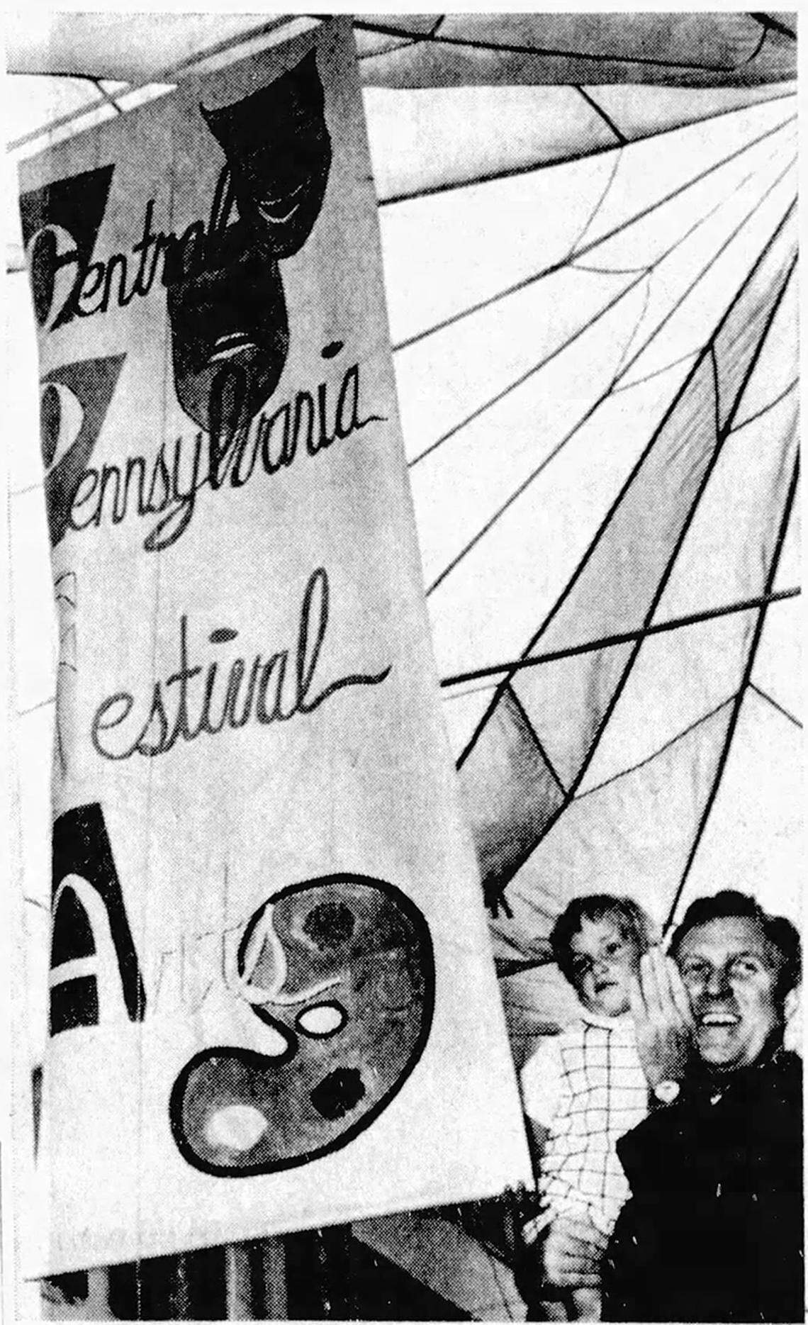 Gov. Raymond Shafer helps open the first Central Pennsylvania Festival of the Arts on July 22, 1967, by unfurling the festival banner.