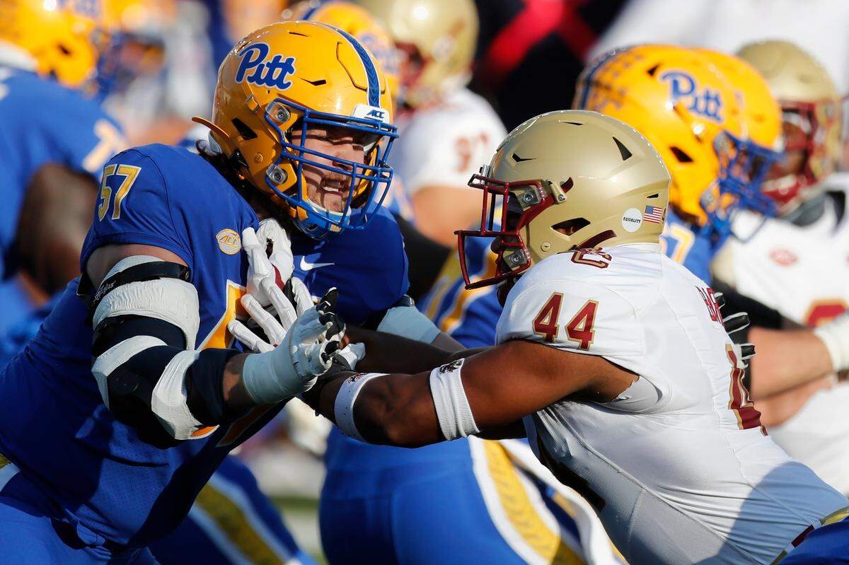 Pittsburgh offensive lineman Gabe Houy (57) plays against Boston College defensive lineman Brandon Barlow (44) during the first half of a game, Saturday, Oct. 10, 2020, in Boston. Houy is from Pittsburgh.