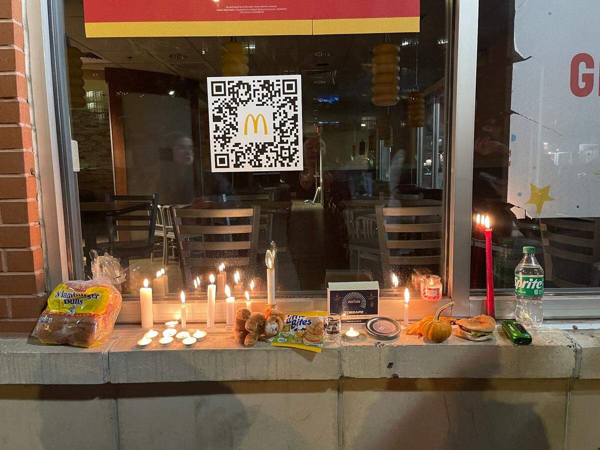 Penn State students gathered Sunday evening for a “candlelight vigil” after the downtown State College McDonald’s closed. They left a number of items on the building’s window, including a stuffed Nittany Lion and a half-eaten cheeseburger.