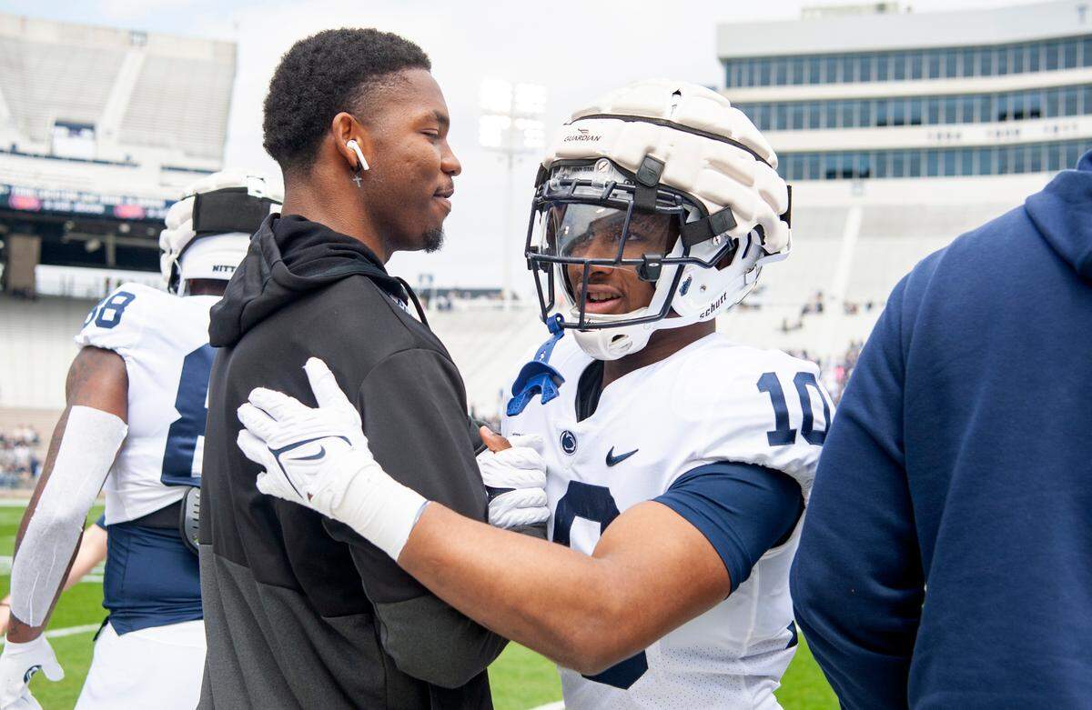 Incoming freshman Dani Dennis-Sutton greets running back Nicholas Singleton who early enrolled, before the Blue-White game on Saturday, April 23, 2022.